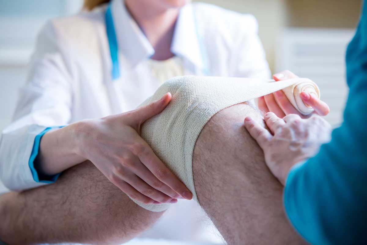 Physical therapist working on an orthopedic knee injury