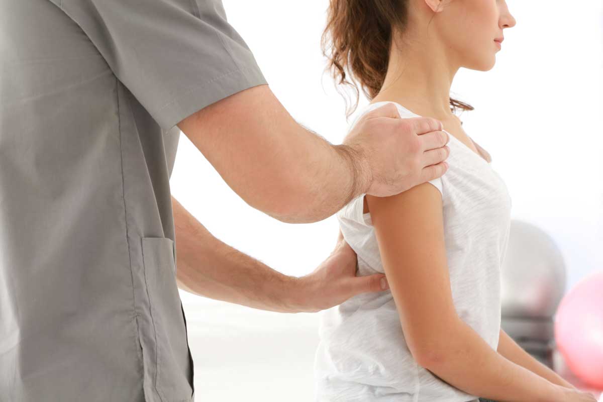 Physical therapist working on a woman's shoulder